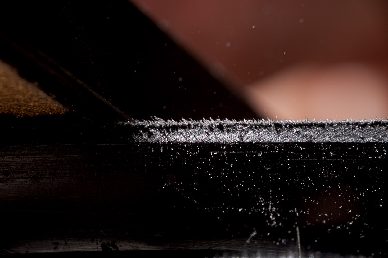detail of knife sharpening - swarf and burr on edge